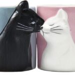 A pair of BigNoseDeer ceramic mugs, one blue and one pink, designed with cat faces that appear to kiss when placed together.
