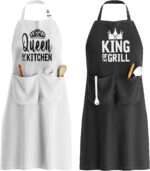Two King and Queen aprons, one white and one black, with crowns and text, in an elegant gift box.