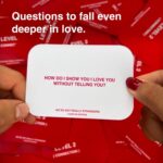 WE'RE NOT REALLY STRANGERS Couples Edition card game box with scattered conversation cards