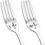 Two silver stainless steel dinner forks, one engraved 'I do' and the other 'me too', arranged on a clean background.
