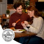A silver, round stainless steel coin with 'Ymapinc' engraved, displaying food choices on one side and date night ideas on the